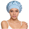 A model wearing a light blue silk satin sleep bonnet with a wide elastic band.