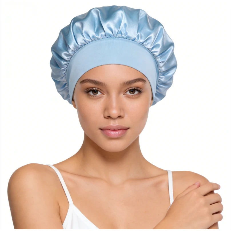 A model wearing a light blue silk satin sleep bonnet with a wide elastic band.