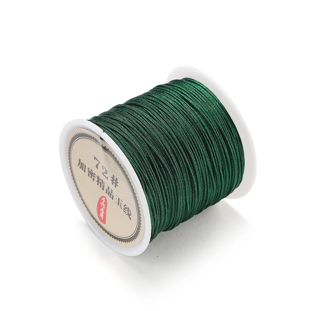 A spool of dark green 0.8mm nylon macramé cord for jewelry making with a white label.