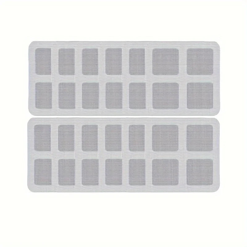 A pack of white mesh filters used as disposable shower drain hair catchers for sinks and floor drains.