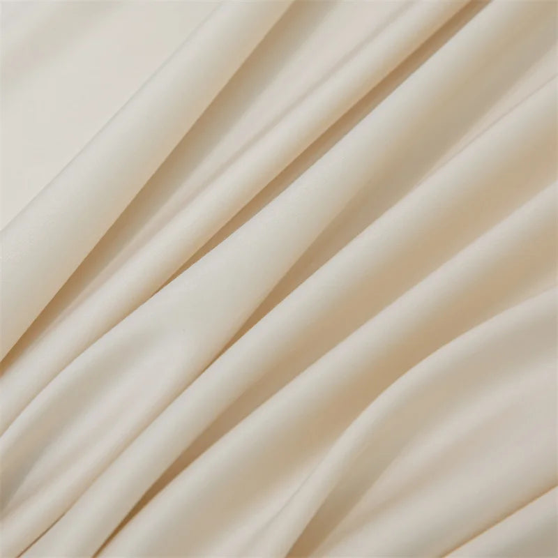 Close-up of flowing, light beige bamboo fabric draped in soft folds.