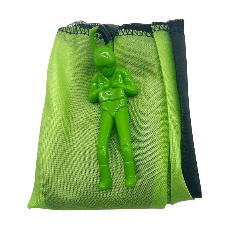 A lime green parachute toy with a small green soldier figure inside.