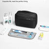 A black waterproof toiletry bag is shown open, with various toiletries like bottles and tubes laid out for travel.