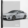 A silver BMW sedan with a dark ceramic tint film applied to the windows.