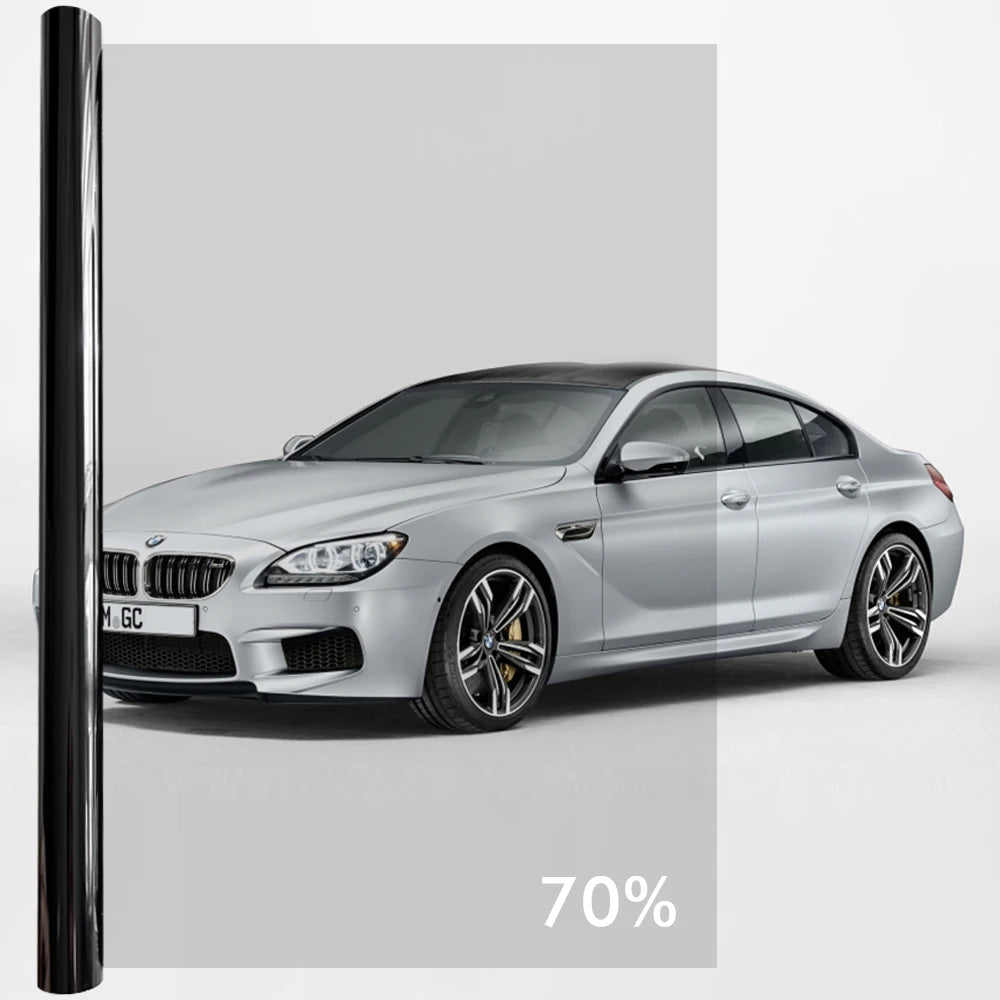 A silver BMW sedan with a dark ceramic tint film applied to the windows.