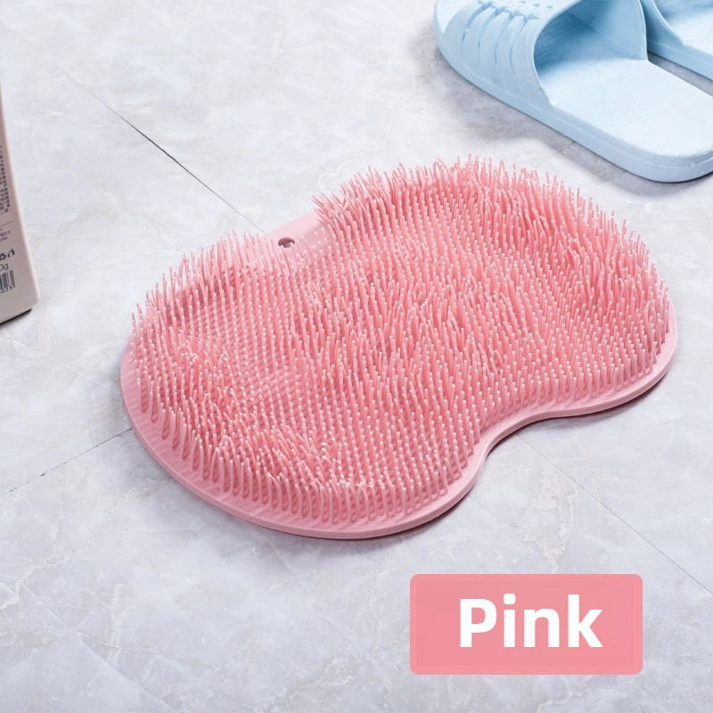 A pink suction cup foot massage mat with exfoliating bristles is shown on a light surface.