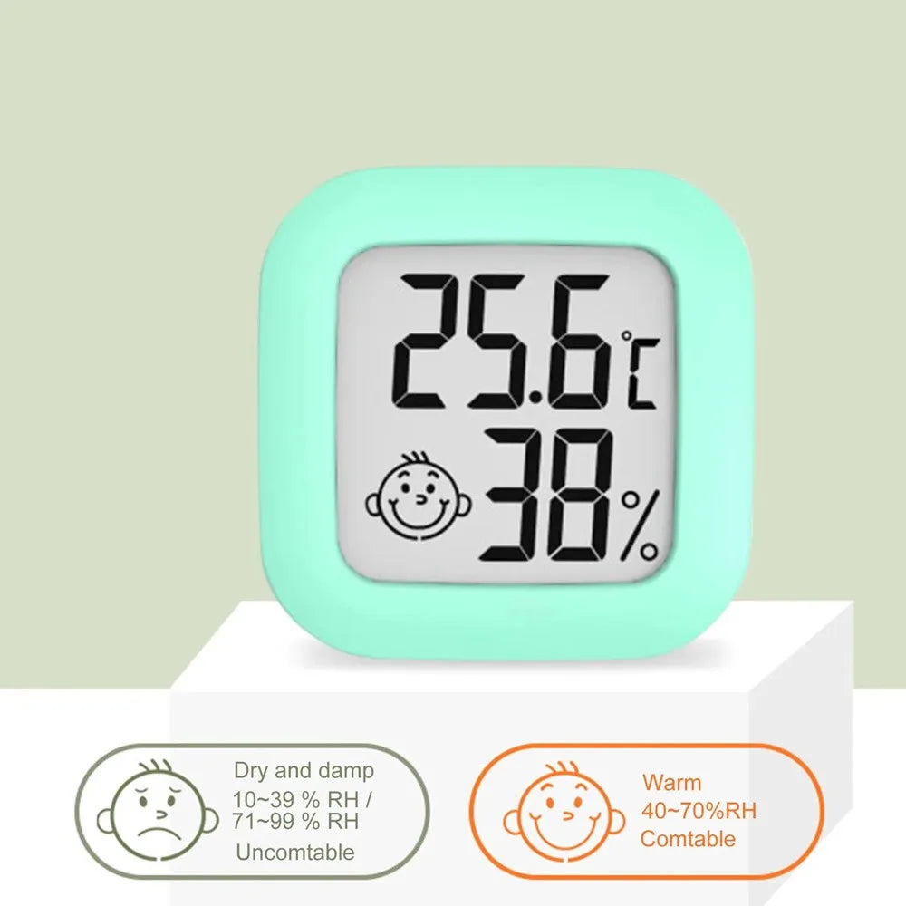 A light mint green compact digital indoor thermometer and hygrometer displaying 25.6°C and 38% humidity.
