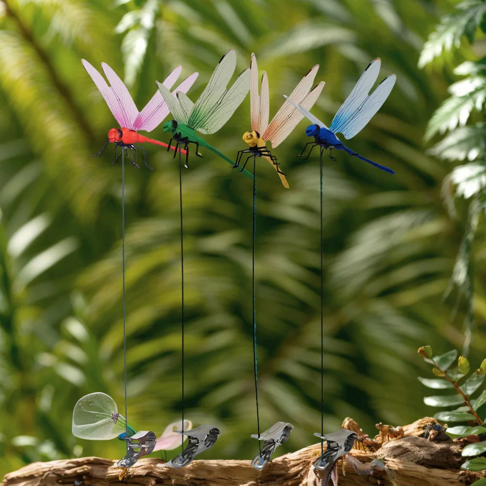 A collection of lifelike dragonfly garden clips with insect repellent designs hanging from a branch.