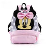 Pink and gray Minnie Mouse themed backpack with a large bow and face print