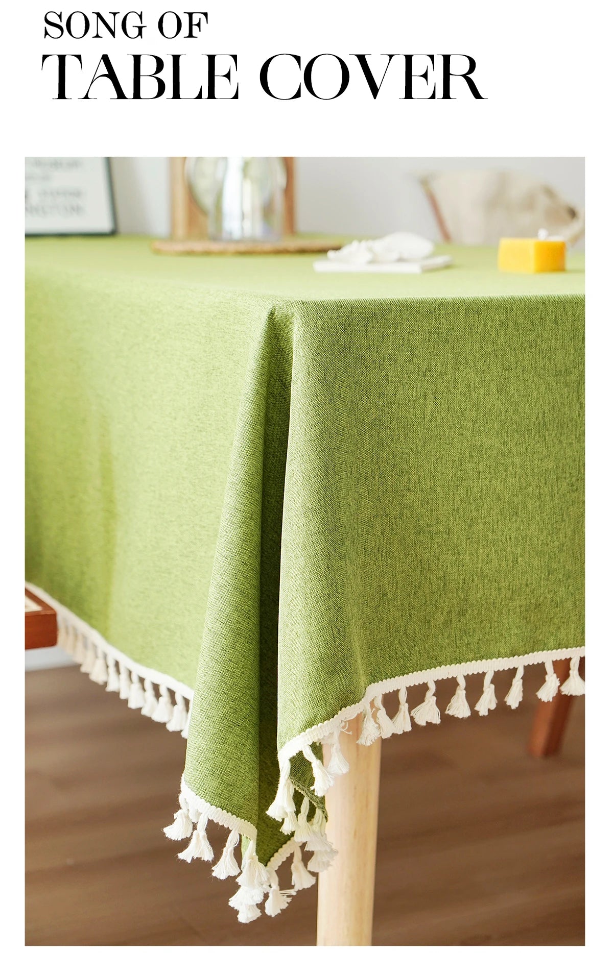 A lime green linen tablecloth with white tassels draped over a wooden table.
