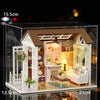 A detailed miniature dollhouse kit featuring a wooden facade, furniture, and decorative elements with integrated LED lights.