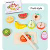 A wooden pretend play set featuring various cut fruit and vegetable shapes like watermelon, lemon, and apple slices.