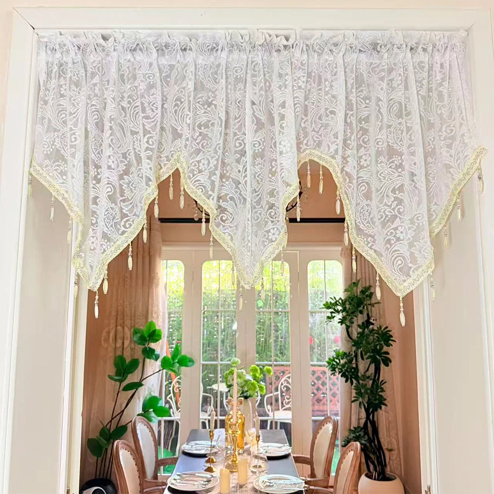 White lace curtain valance with fringe and irregular pendant for a window frame
