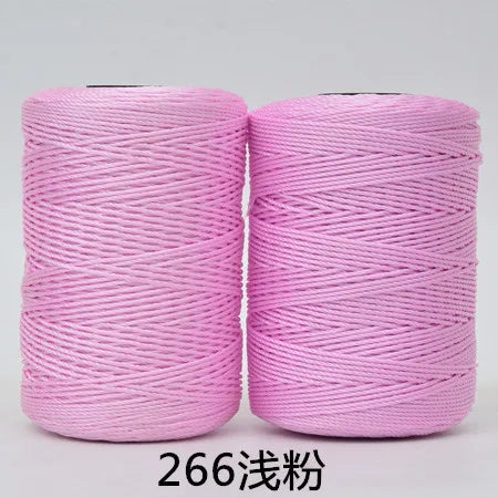 Two spools of pink 3-ply polyester knitting yarn for crochet and hand crafts