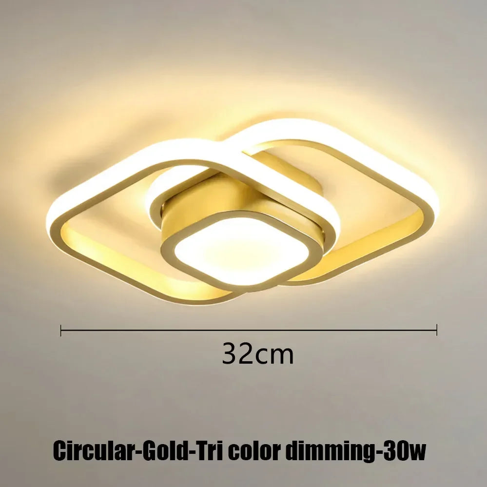 A modern circular gold LED ceiling light fixture with a diffused glow.