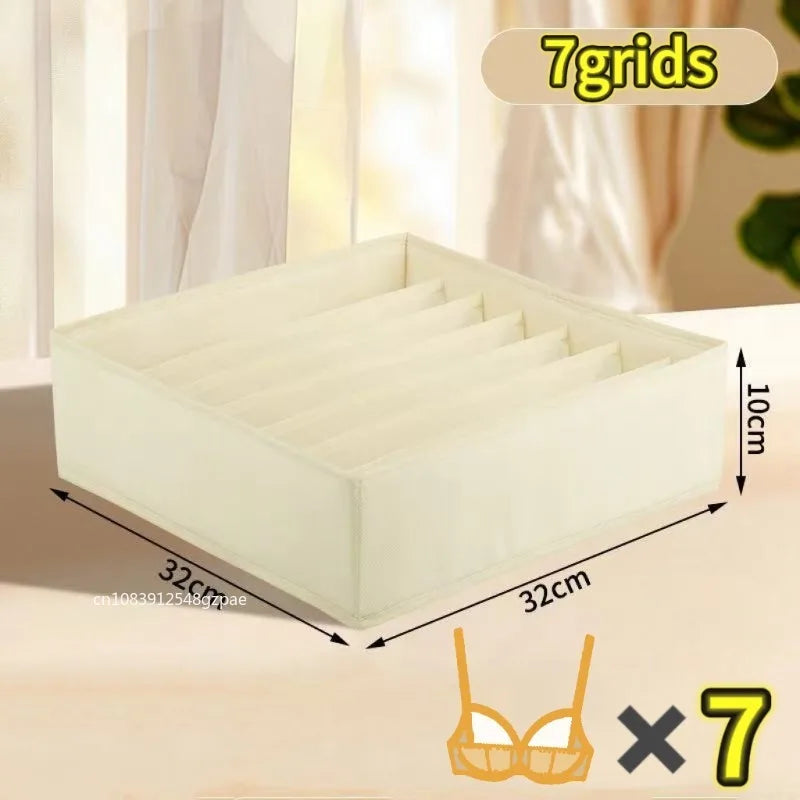 A white fabric organizer with seven dividers is shown on a table, next to a bra, indicating a set of seven organizers.
