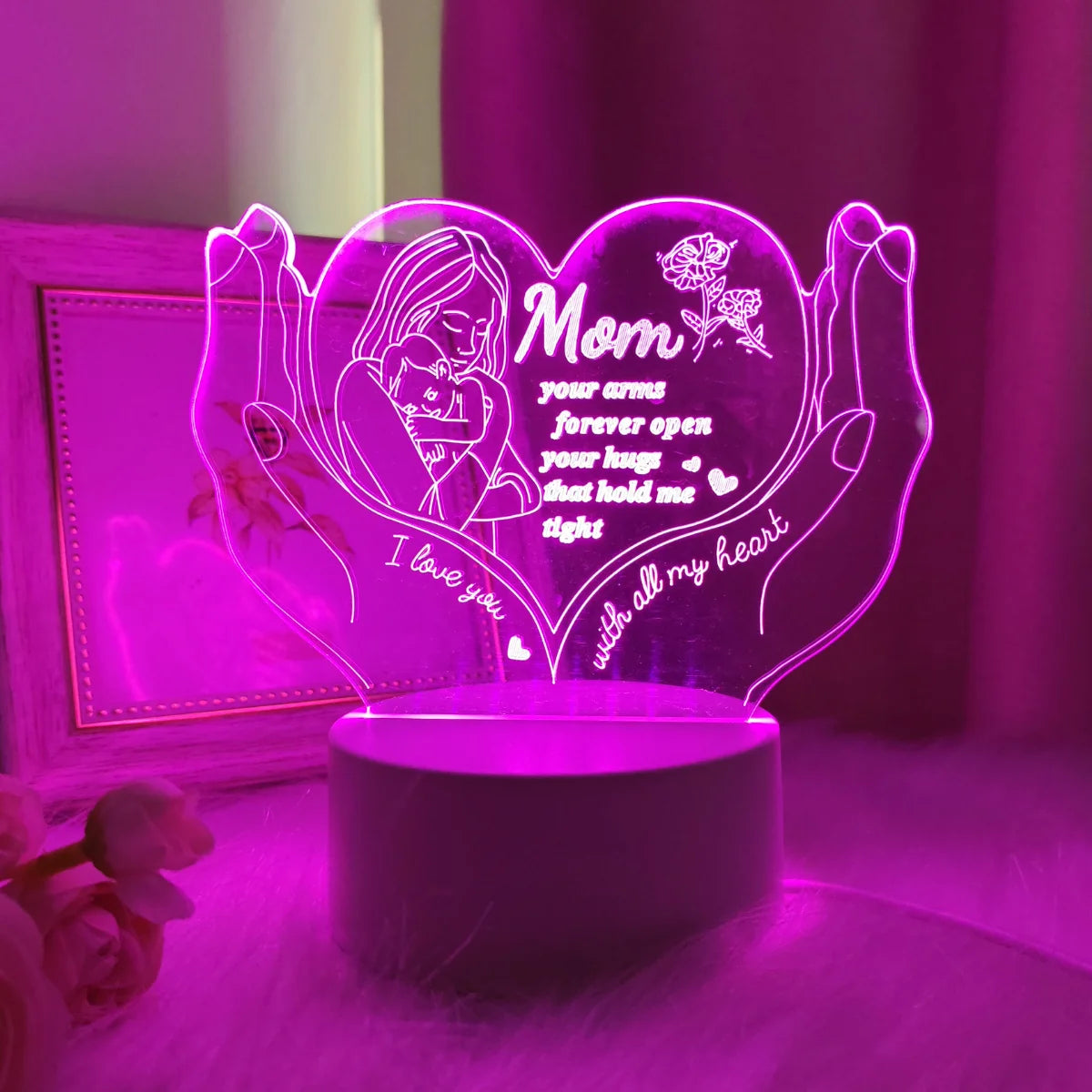 A glowing heart-shaped LED night light featuring a silhouette of a mother's arms and the text I love you with all my heart.