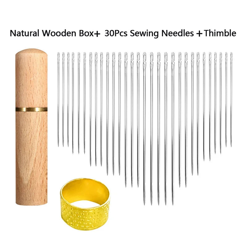 A set of 30 metal sewing needles and a thimble are displayed next to a natural wooden box.