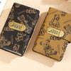A brown patterned notebook with a black cover and a gold lockable mechanism featuring cartoon bears.