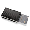 A black textured leather card holder with a silver trim displaying several cards.