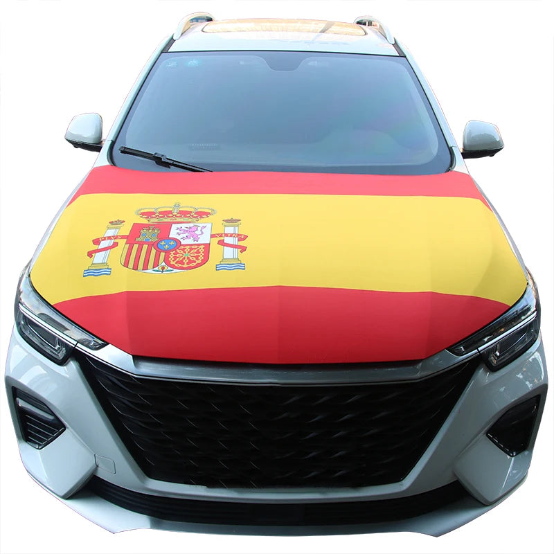 A white car hood covered with the Spanish national flag design featuring red and yellow stripes and heraldic symbols.