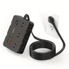 A black flat power strip with six outlets and four USB ports connected by a long black cord.