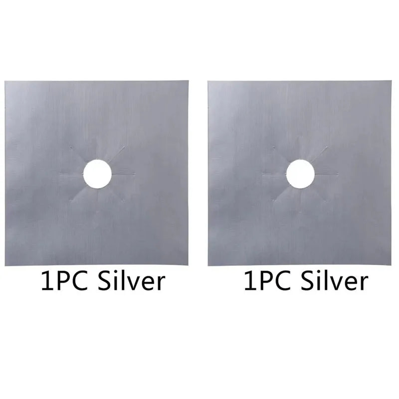 Two square silver metal stove burner mats, each with a circular hole.