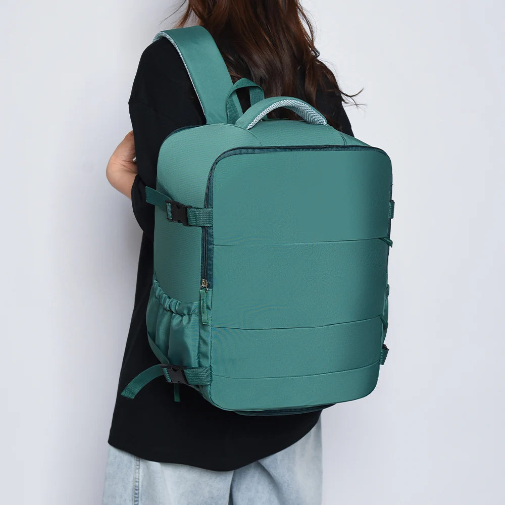 A teal travel backpack is shown being worn by a person against a white background.