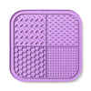 A purple silicone lick mat for dogs and cats with suction cups, divided into four textured sections.