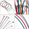 A collection of six color-coded acoustic guitar strings in various shades including red, green, yellow, and blue.