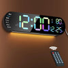 A large digital wall clock displaying time and day, with an RGB color changing remote nearby.