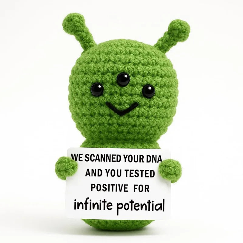 Handmade crochet green hedgehog doll with a white card that reads we scanned your dna and you tested positive for infinite po
