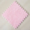 A square pink plush interlocking floor tile with a textured surface.