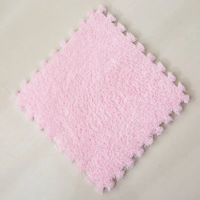 A square pink plush interlocking floor tile with a textured surface.