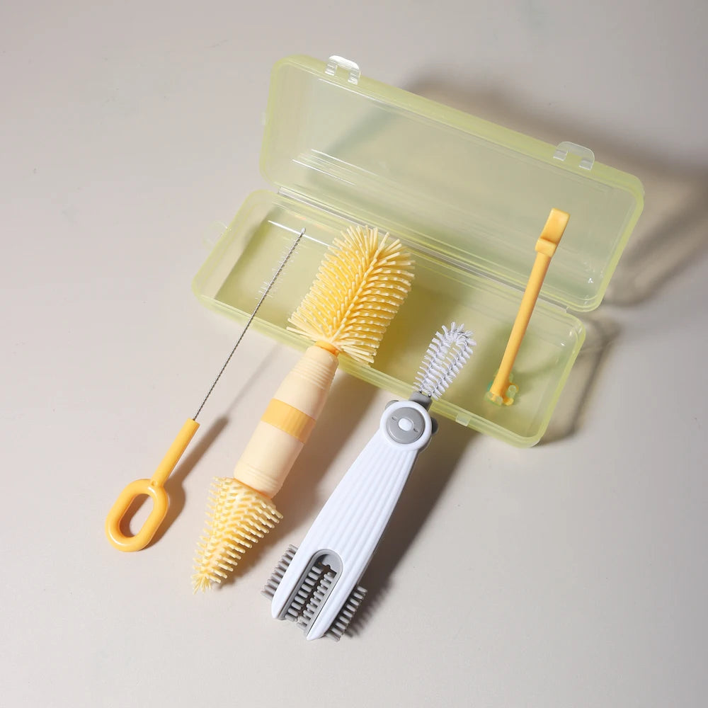 A silicone baby bottle cleaning set with a light green case and three yellow brushes.