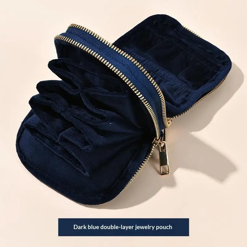 Dark blue double-layer jewelry pouch with a gold zipper and velvet lining