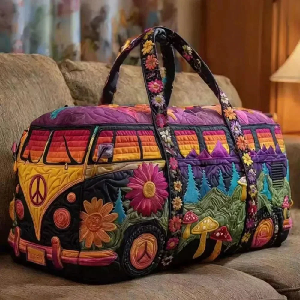 A colorful quilted travel duffle bag featuring a vibrant landscape design with floral and natural elements.