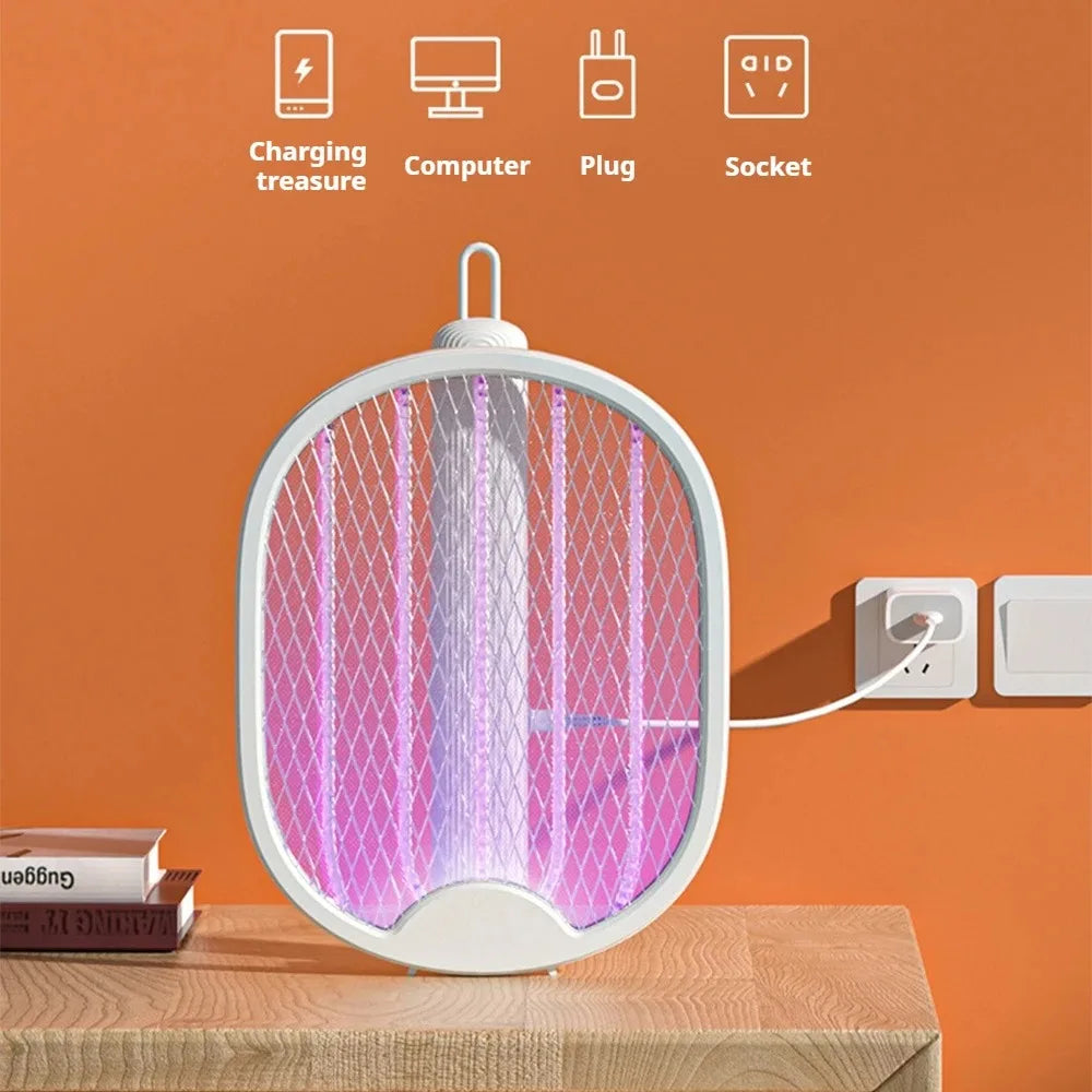 A white, circular electric mosquito swatter with a pink UV light is displayed on a wooden surface.