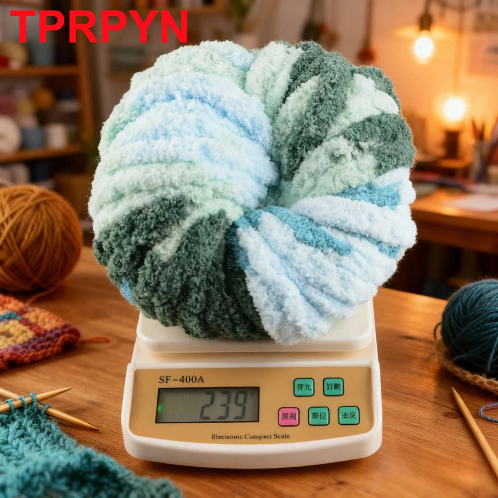 A ball of light blue and green chunky chenille yarn resting on a digital scale.