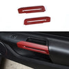 Two red carbon fiber door handle covers for a Ford Mustang