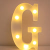 A glowing letter G made of LED lights used as a night light or party decor.