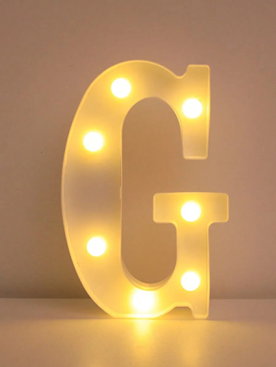 A glowing letter G made of LED lights used as a night light or party decor.