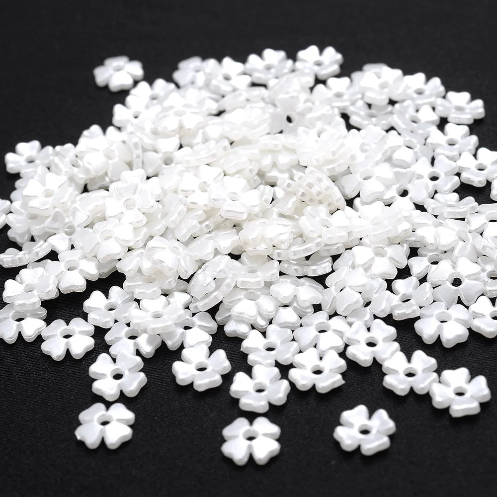 A pile of 100 white acrylic pearl spacer beads for jewelry making