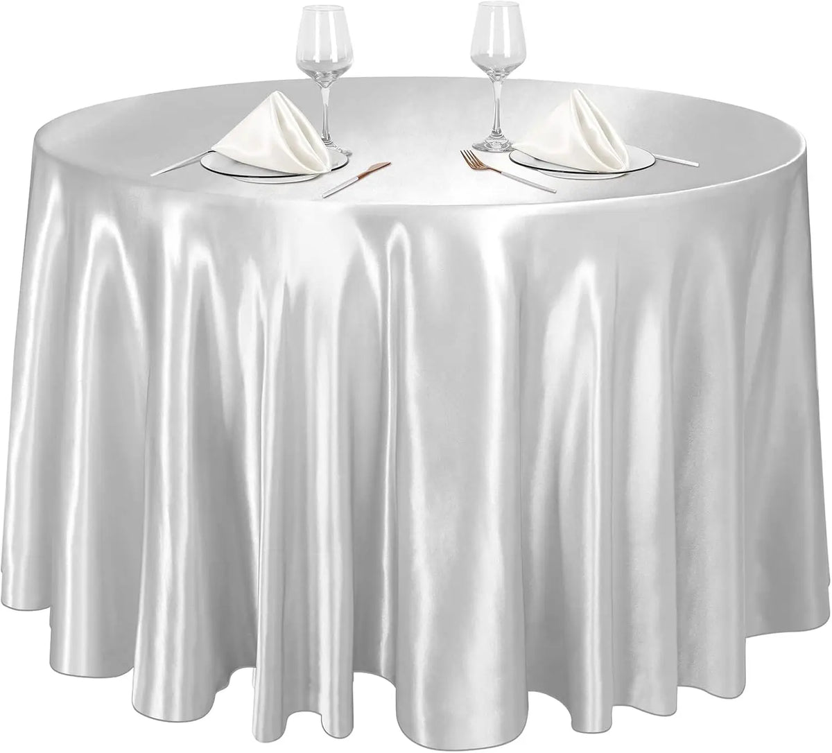 A round silver satin tablecloth set for events featuring glassware and napkins.