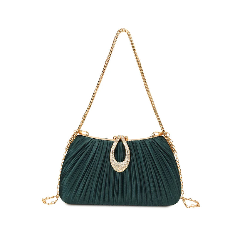 A dark teal pleated evening clutch with a gold chain strap and a rhinestone pendant.