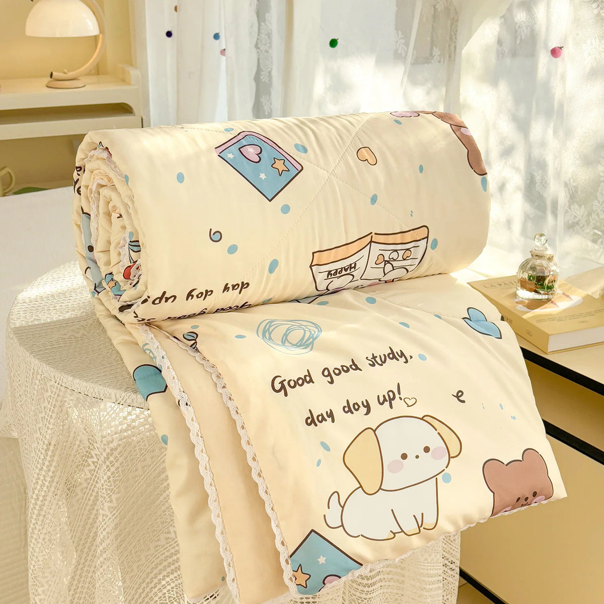 A cream-colored lightweight summer comforter with a panda print featuring cute illustrations and lace trim.