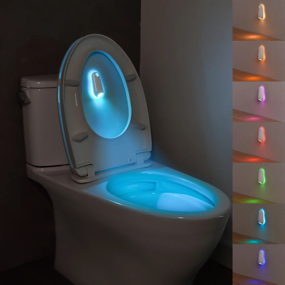 A white toilet features a glowing blue light in the seat and a vertical strip of seven colored lights on the side.