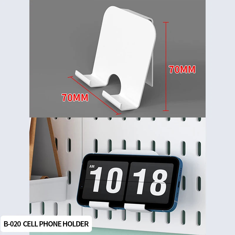 A white cell phone holder is shown against a pegboard organizer with multiple hooks and shelves.