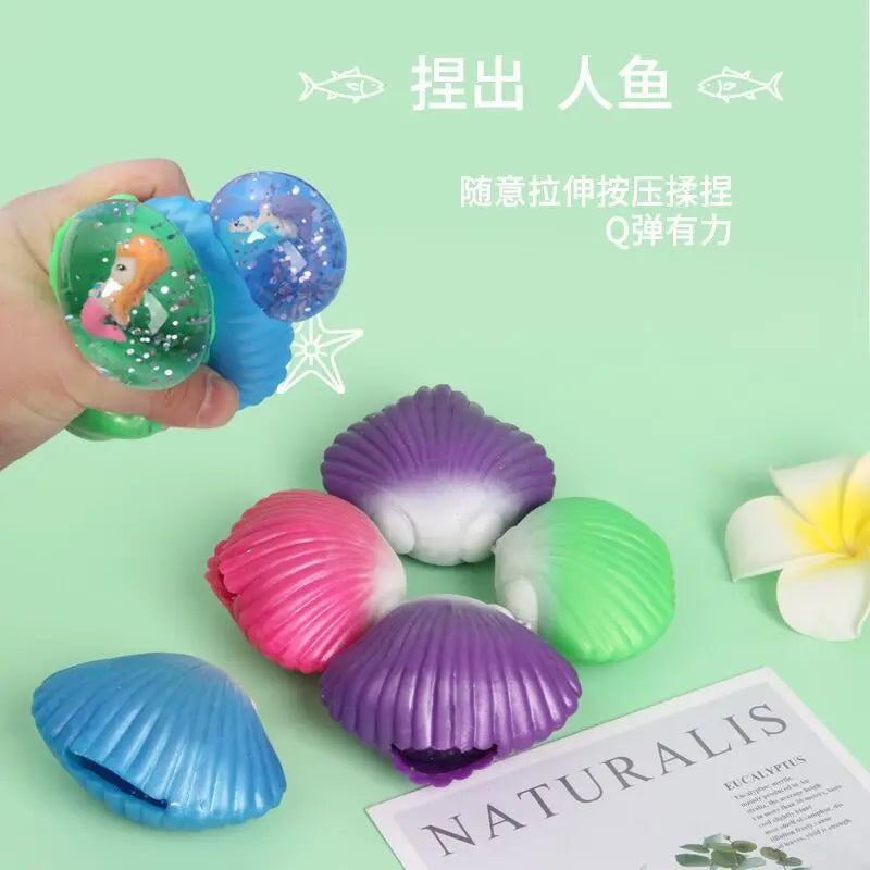 A collection of purple, pink, and green mermaid shells used as a squeeze toy or fidget ball for stress relief.