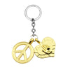 Gold pendant necklace featuring a peace sign and a stylized face design.
